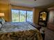 Bedroom featuring a large window with a view, a king-sized bed, and hardwood furniture at 530 Sandy Hook Rd, Treasure Island, FL 33706