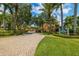 Beautiful community entrance with manicured landscaping and stately signage for Village on Venetian Bay at 530 Sandy Hook Rd, Treasure Island, FL 33706