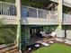 Exterior of the home featuring a patio with seating and a backyard with a landscaped space at 530 Sandy Hook Rd, Treasure Island, FL 33706