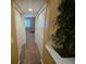 Hallway leading to a room, with a decorative plant to the side at 530 Sandy Hook Rd, Treasure Island, FL 33706