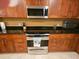 Modern kitchen with stainless steel appliances, granite countertops, and updated cabinetry at 530 Sandy Hook Rd, Treasure Island, FL 33706