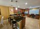 Open concept kitchen with stainless steel appliances, dark granite countertops, and black leather barstools at 530 Sandy Hook Rd, Treasure Island, FL 33706