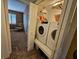 Laundry room with new front load washer and dryer, storage, and access to a bedroom at 530 Sandy Hook Rd, Treasure Island, FL 33706