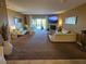 Spacious living room featuring a fireplace, plush carpeting, stylish furnishings, and access to a private balcony at 530 Sandy Hook Rd, Treasure Island, FL 33706