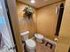 Small powder room with a bidet, a textured wall, and unique decor at 530 Sandy Hook Rd, Treasure Island, FL 33706