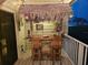 An outdoor tiki bar with a thatched roof, stools, decorations, and string lights at 530 Sandy Hook Rd, Treasure Island, FL 33706