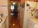 A view of the kitchen through the hallway, featuring updated appliances and layout at 5660 80Th N St # A205, St Petersburg, FL 33709
