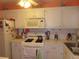 Compact kitchen with white cabinets, standard appliances, and functional design at 5660 80Th N St # A205, St Petersburg, FL 33709