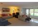 Spacious living room with large windows, neutral carpet, and comfortable seating at 5660 80Th N St # A205, St Petersburg, FL 33709
