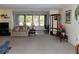 Comfortable living room featuring neutral carpet, sofa and additional seating at 5660 80Th N St # A205, St Petersburg, FL 33709
