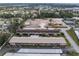 An aerial view of multi-Gathering units with parking, a future building site, and mature landscaping surrounding the area at 5967 Terrace Park N Dr # 202, St Petersburg, FL 33709
