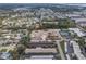 An aerial view shows the multi-Gathering complex close to residential homes, an empty lot, and a few recreational areas at 5967 Terrace Park N Dr # 202, St Petersburg, FL 33709
