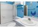 Bathroom view showcasing a combined shower-tub, toilet, and sink with ocean decorations at 5967 Terrace Park N Dr # 202, St Petersburg, FL 33709