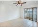 Spacious bedroom with tile floors, sliding glass doors to a sunroom, and ceiling fan at 5967 Terrace Park N Dr # 202, St Petersburg, FL 33709