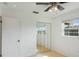 Well-lit bedroom with mirrored closet doors, tile flooring, and modern ceiling fan at 5967 Terrace Park N Dr # 202, St Petersburg, FL 33709
