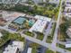 Aerial view showcases a community center with tennis courts, pool, and parking at 5967 Terrace Park N Dr # 202, St Petersburg, FL 33709