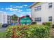 Exterior view of the community with sign. Lush greenery at 5967 Terrace Park N Dr # 202, St Petersburg, FL 33709