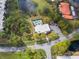 Aerial view showcases community amenities including a pool, pond, and lush landscaping at 5967 Terrace Park N Dr # 202, St Petersburg, FL 33709