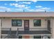 Condo exterior with a cozy porch, showing the unit number and a staircase leading to other units at 5967 Terrace Park N Dr # 202, St Petersburg, FL 33709