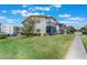 Exterior elevation of this multi-Gathering community featuring mature landscaping and ample parking at 5967 Terrace Park N Dr # 202, St Petersburg, FL 33709