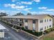 Exterior of a multi-Gathering home with neatly trimmed bushes, showing multiple windows and an open porch at 5967 Terrace Park N Dr # 202, St Petersburg, FL 33709