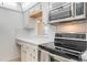 Close-up of the kitchen area, including countertops and oven, and stainless steel microwave at 5967 Terrace Park N Dr # 202, St Petersburg, FL 33709