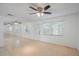 Inviting living room boasts neutral tiling, a modern ceiling fan, and lots of natural light at 5967 Terrace Park N Dr # 202, St Petersburg, FL 33709