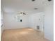 A bright living room with tile floors, recessed lighting, and a view into the kitchen at 5967 Terrace Park N Dr # 202, St Petersburg, FL 33709