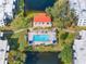 Aerial view of a sparkling community pool surrounded by lounge chairs and landscaping at 5967 Terrace Park N Dr # 202, St Petersburg, FL 33709
