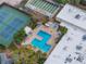 Aerial view of a refreshing pool area with tennis court and shuffleboard amenities at 5967 Terrace Park N Dr # 202, St Petersburg, FL 33709