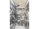 Walk in shower featuring marble tile and a shower head at 5967 Terrace Park N Dr # 202, St Petersburg, FL 33709