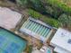Aerial view of shuffleboard courts near tennis courts, pool, and building at 5967 Terrace Park N Dr # 202, St Petersburg, FL 33709