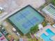 Aerial view of tennis courts plus pool with surrounding landscaping and parking at 5967 Terrace Park N Dr # 202, St Petersburg, FL 33709