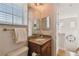 Cozy half bathroom with a granite countertop sink and a large round clock at 6030 Printery St # 108, Tampa, FL 33616