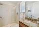 Bright bathroom featuring a glass-enclosed shower and granite countertop sink at 6030 Printery St # 108, Tampa, FL 33616