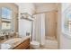 Bathroom featuring granite vanity, soaking tub, and tile flooring at 6030 Printery St # 108, Tampa, FL 33616