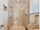 Modern bathroom with glass shower and tan tile at 6030 Printery St # 108, Tampa, FL 33616