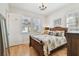 Bedroom with wood flooring, chandelier, and ample natural light at 6030 Printery St # 108, Tampa, FL 33616