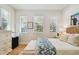 Bright bedroom featuring neutral tones, hardwood floors and three windows at 6030 Printery St # 108, Tampa, FL 33616