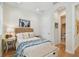 Cozy bedroom featuring neutral tones, hardwood floors and adjacent bathroom at 6030 Printery St # 108, Tampa, FL 33616