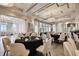 Formal dining room with elegantly set tables and chairs under soft, ambient lighting at 6030 Printery St # 108, Tampa, FL 33616