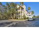 Attractive multi-story townhome featuring balconies, mature trees, and a corner lot at 6030 Printery St # 108, Tampa, FL 33616