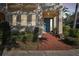 Inviting home entrance with a blue door, red brick steps, and lush landscaping at 6030 Printery St # 108, Tampa, FL 33616