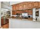 A modern kitchen features wood cabinets, stainless steel appliances, granite counters, and an open layout at 6030 Printery St # 108, Tampa, FL 33616
