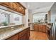 A kitchen featuring stainless steel appliances, wood cabinets, granite countertops, and hardwood floors at 6030 Printery St # 108, Tampa, FL 33616