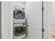 Laundry room features a stacked washer and dryer with white door at 6030 Printery St # 108, Tampa, FL 33616