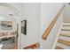 View from the stairs to a living room with a sofa and area rug at 6030 Printery St # 108, Tampa, FL 33616