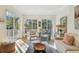 Sun-filled living room featuring large windows, stylish furnishings, and hardwood floors at 6030 Printery St # 108, Tampa, FL 33616