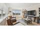 Comfortable living room with two leather chairs, large window, and wooden entertainment center at 6030 Printery St # 108, Tampa, FL 33616