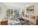 Bright and airy living room with hardwood floors, neutral decor, and large windows providing ample natural light at 6030 Printery St # 108, Tampa, FL 33616